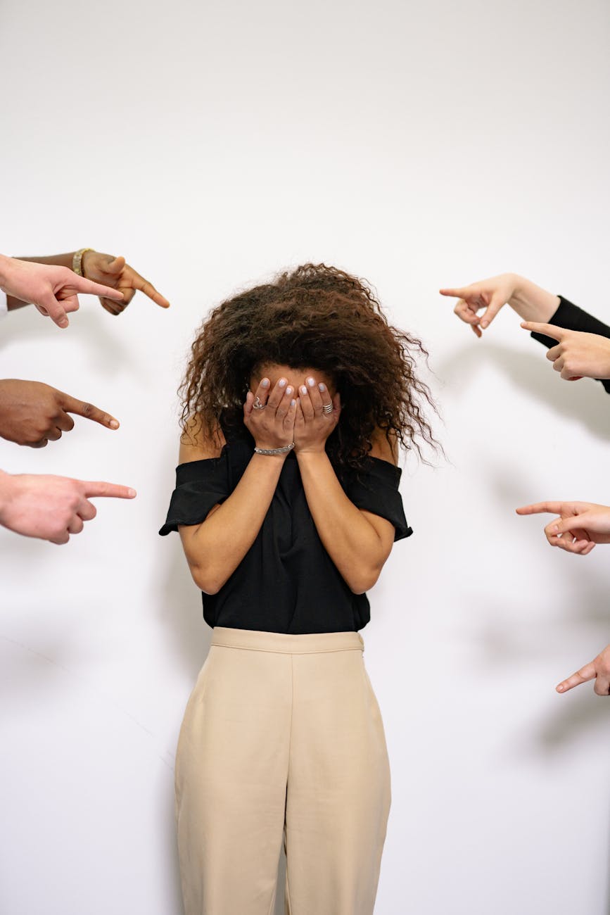 people pointing fingers at a stressed woman