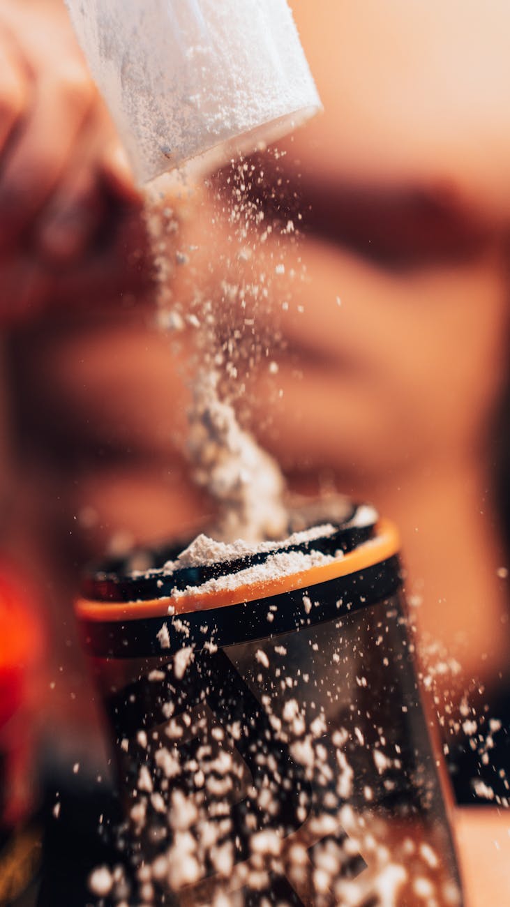 close up of preparing protein shake with powder