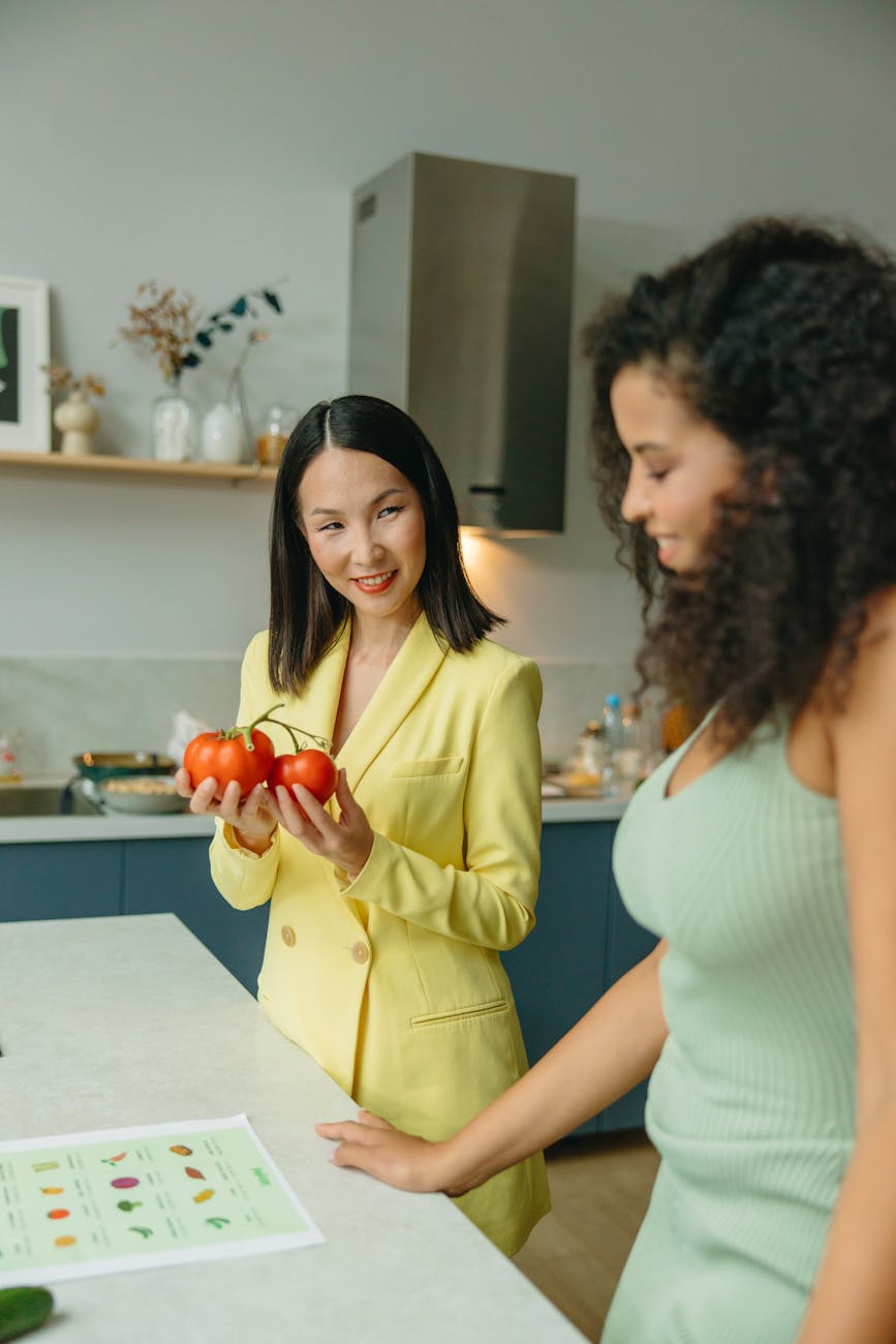 woman smiling while holding tomatoes